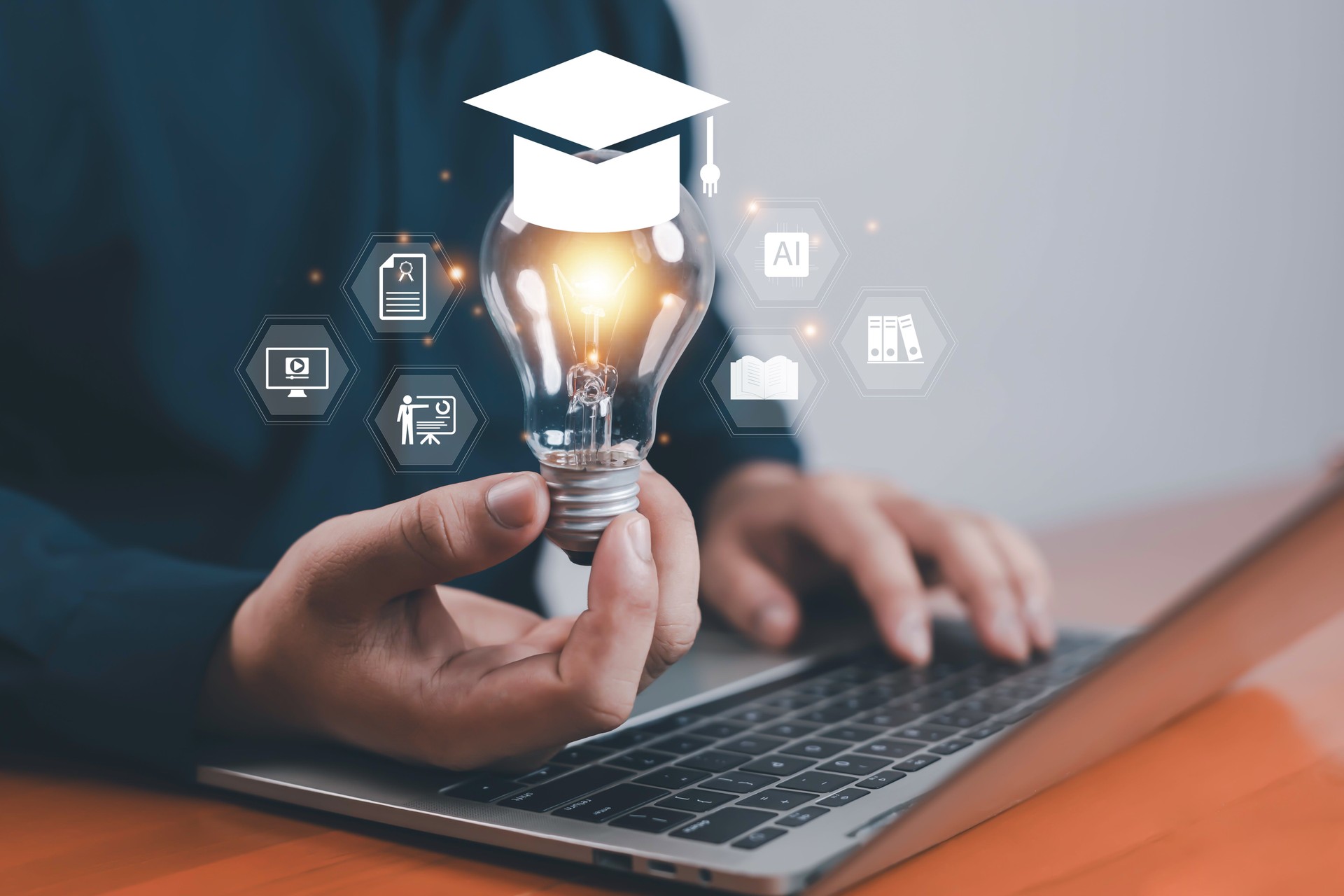 Businessman holding light bulb with graduation cap icon and education symbols, representing e-learning, knowledge innovation, online education, and smart digital learning technology.
