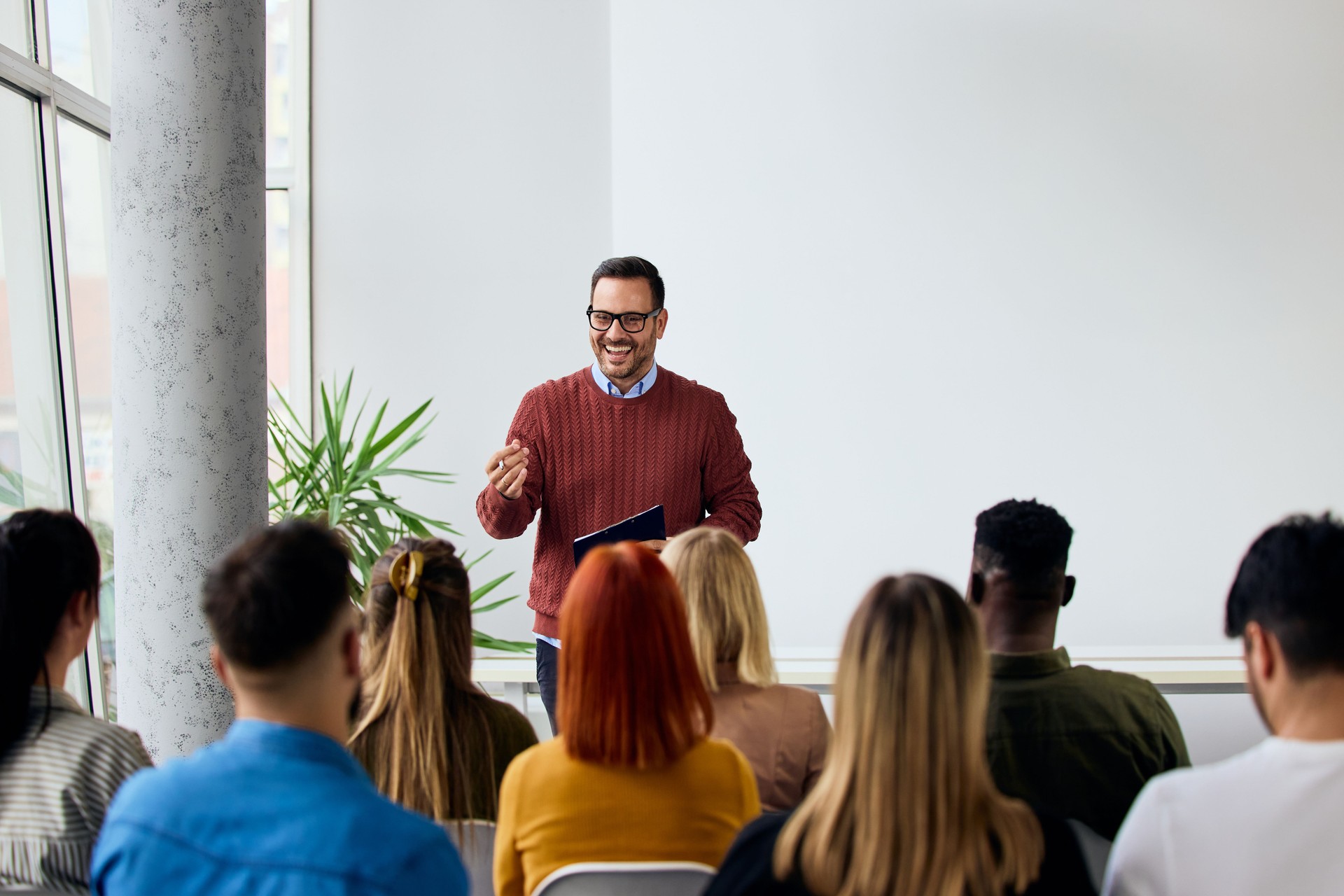 Professional Speaker Conducting Corporate Training Session for Engaged Employees in a Modern Office